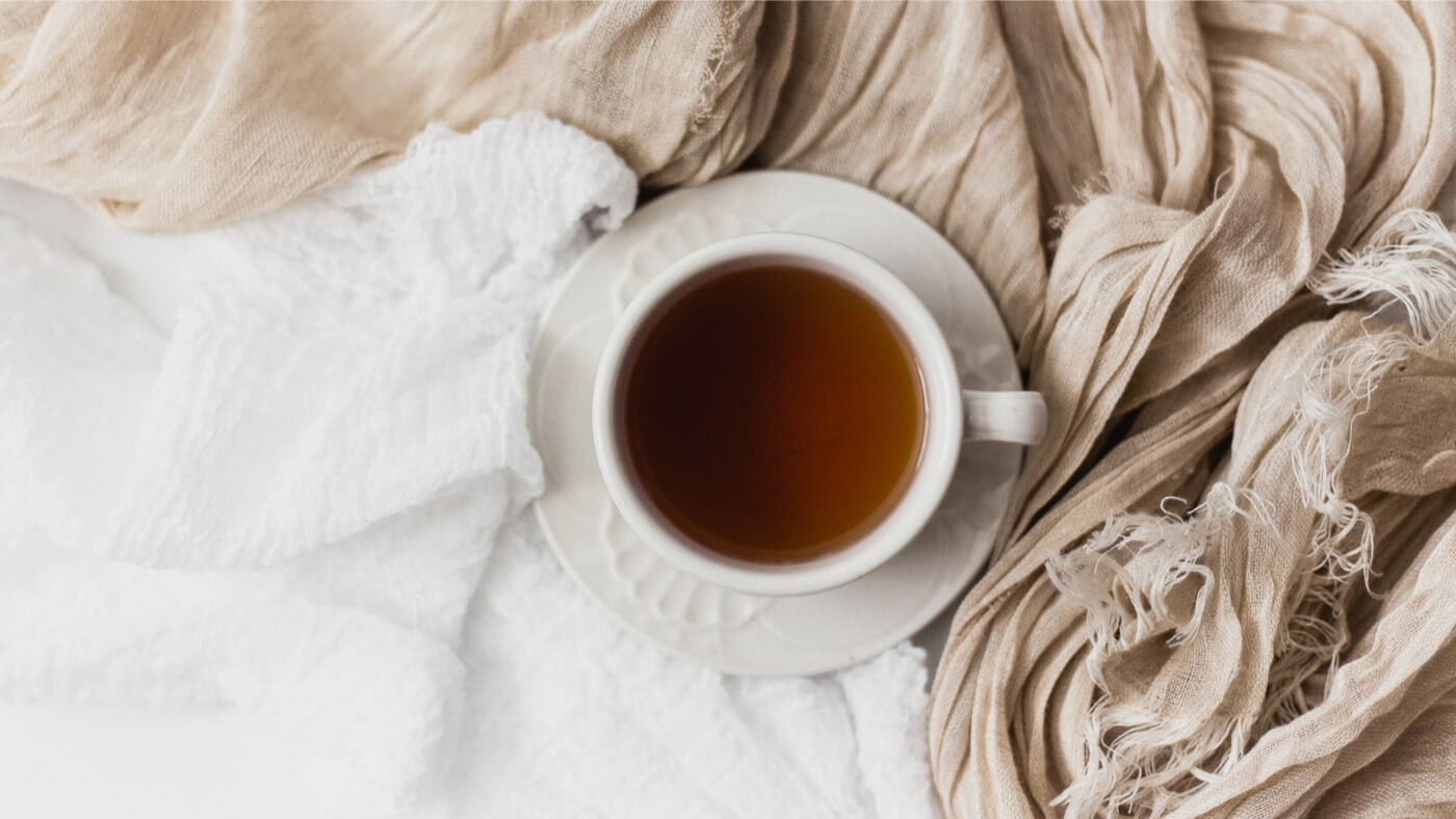 A cup of herbal tea on a scarf